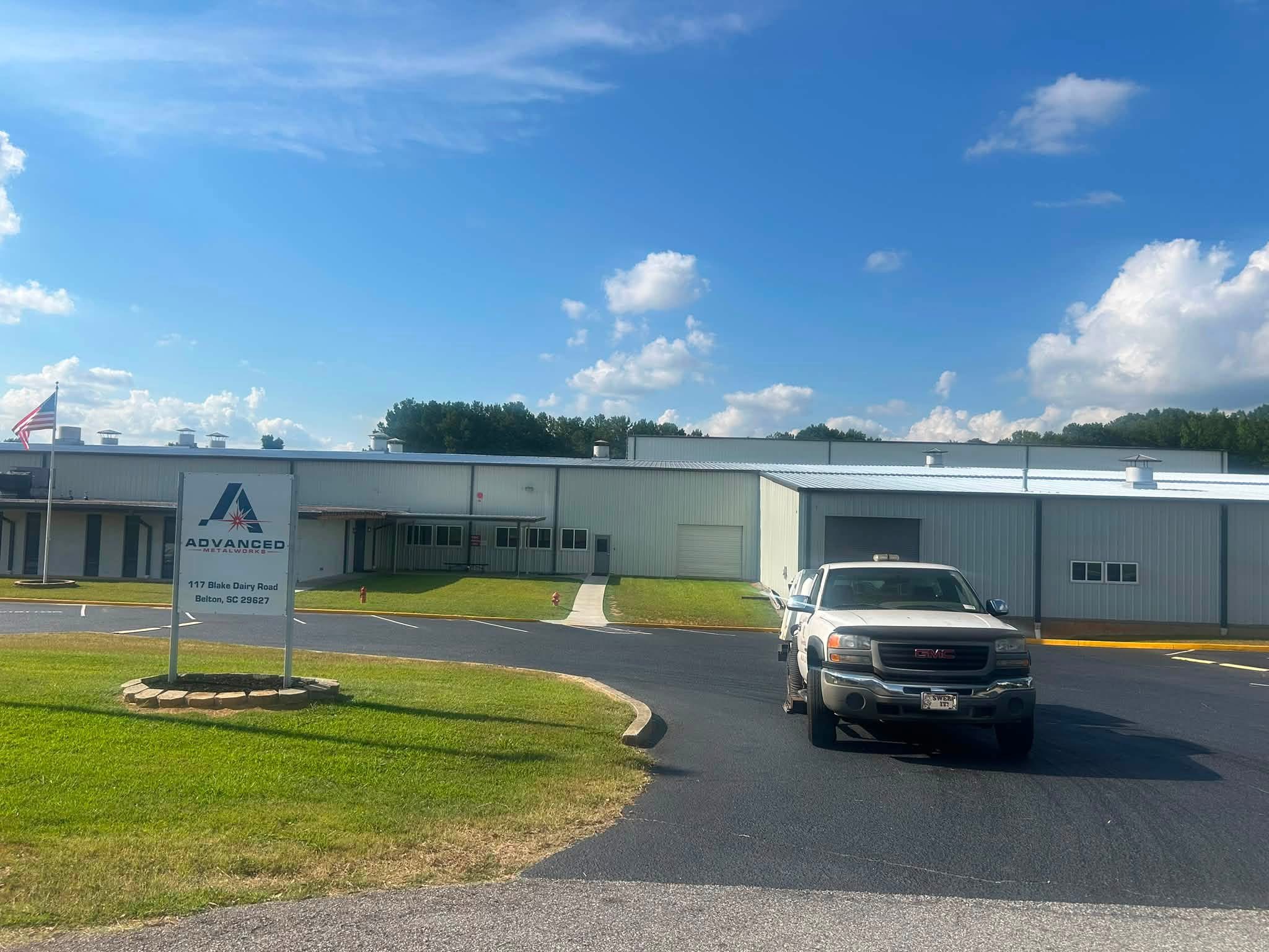 The Advanced Metalworks commercial building and parking lot at 117 Blake Dairy Road, Belton, SC, with a pickup truck parked in the lot